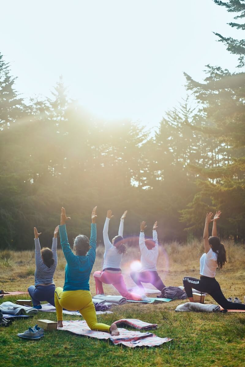 group of people practicing sun salutations yoga