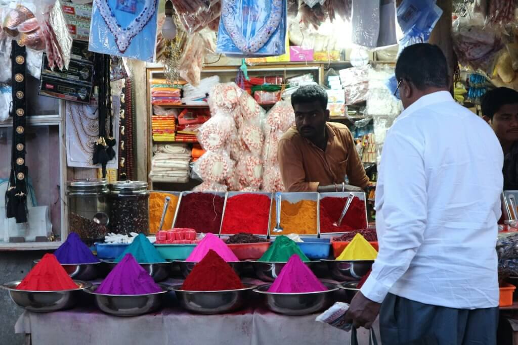 man selling colored sand